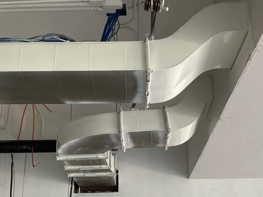 Ventilation system with large air ducts and cables.